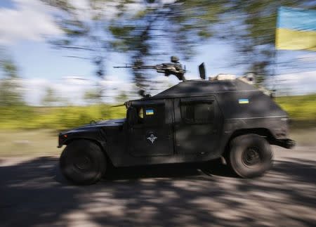 Ukrainian servicemen ride in an armoured vehicle in Kramatorsk August 30, 2014. REUTERS/Gleb Garanich