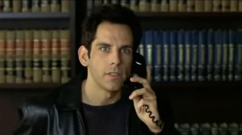 Man stares into camera while on the phone in "Keeping the Faith"