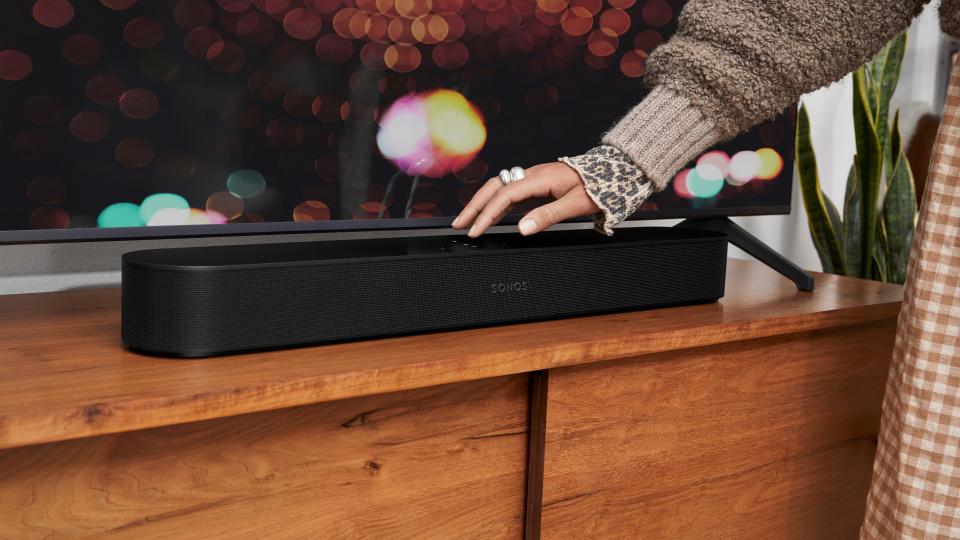 Sonos Beam Gen 2 being caressed by a woman's hand