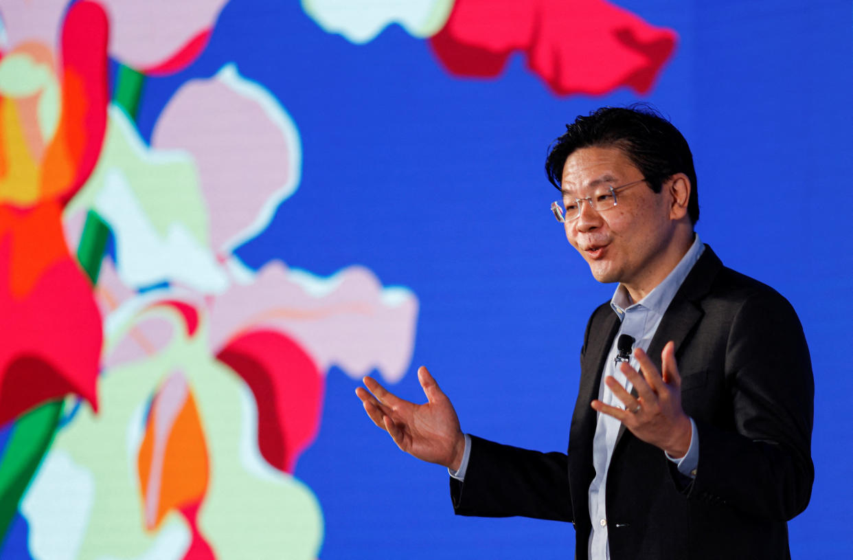 Singapore's Deputy Prime Minister and Minister for Finance Lawrence Wong against a colourful backdrop featuring orchids, to illustrate a story on the Budget Statement.