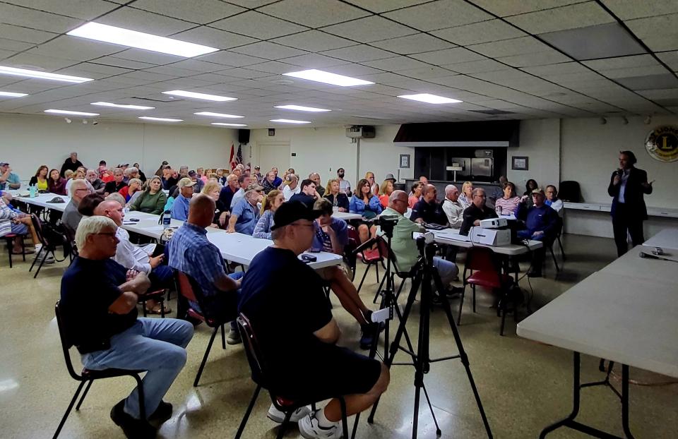 Harsens Islanders listen on while Dan Johnson, chief technology officer for OneWater, the company behind Algaewheel, breaks down the wastewater treatment process with the algae plant proposed for the Sans Souci area of Clay Township during a town hall on Thursday, Aug. 17, 2023.
