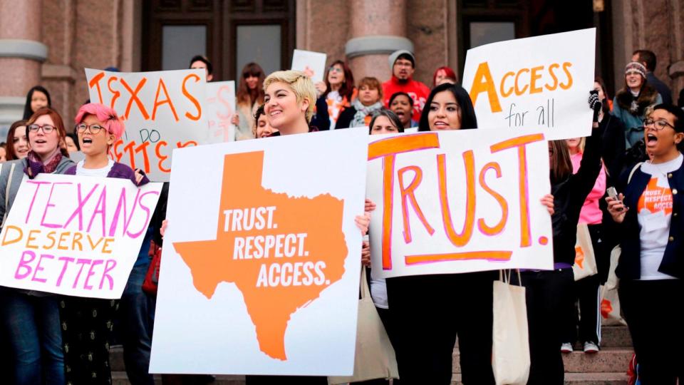 PHOTO: College students and abortion rights activists hold signs during a rally on the steps of the Texas Capitol, in Austin, Texas. (Eric Gay/AP, FILE)