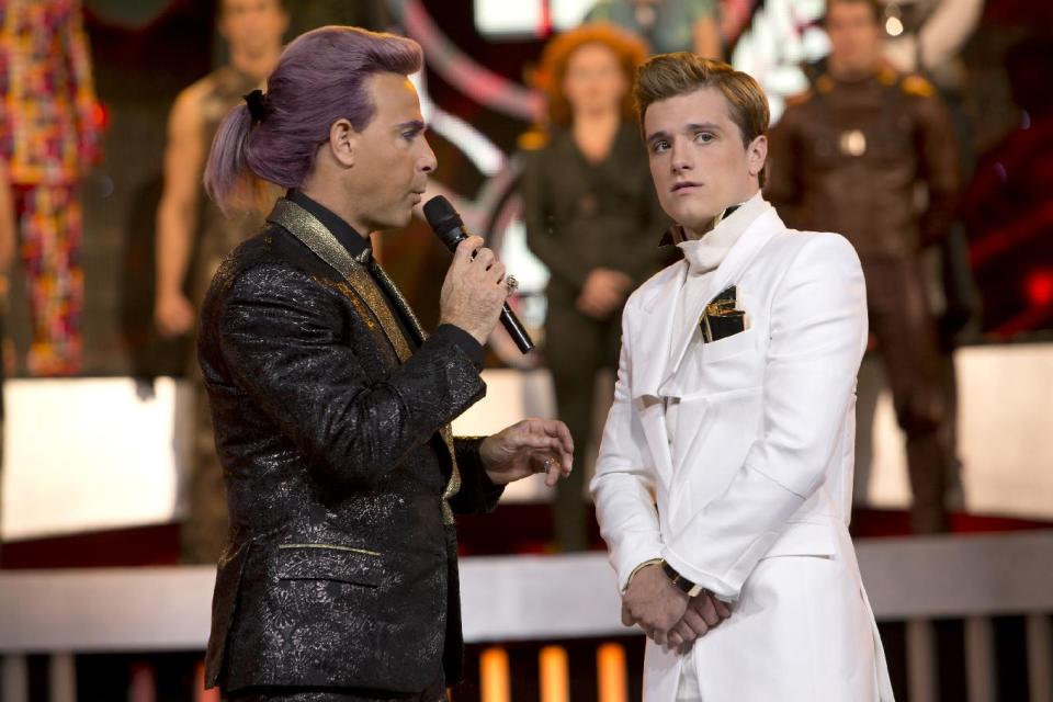 This image released by Lionsgate shows Stanley Tucci as Caesar Flickerman, left, and Josh Hutcherson as Peeta Mellark in a scene from "The Hunger Games: Catching Fire." (AP Photo/Lionsgate, Murray Close)