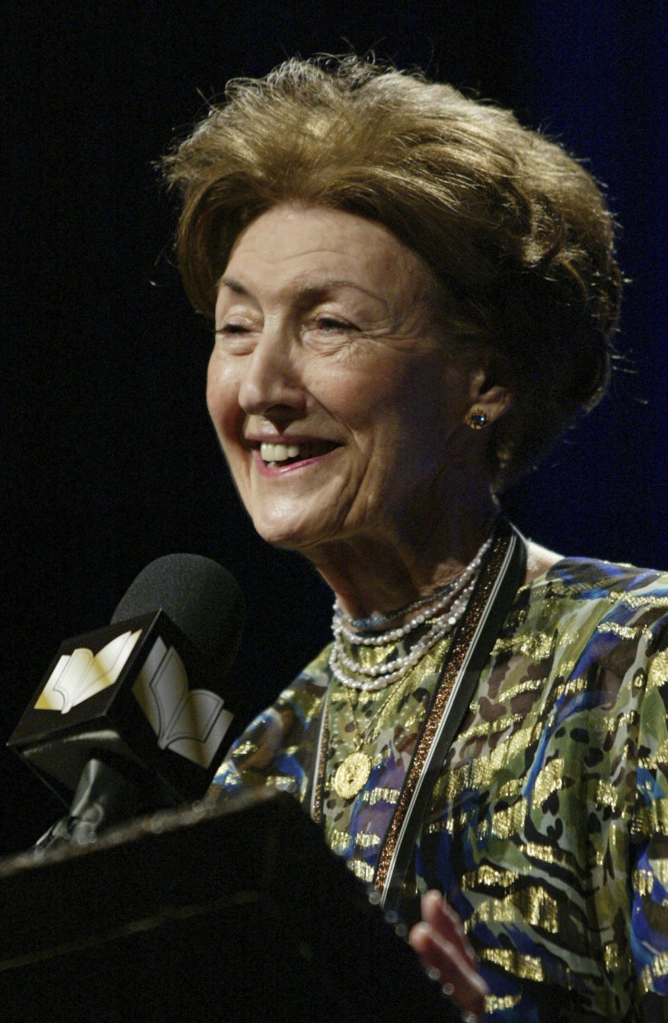 FILE - In this Nov. 19, 2003 file photo, Shirley Hazzard makes her acceptance speech after winning the Fiction category at the 2003 National Book Awards in New York City, with her book titled "The Great Fire." The award-winning novelist Hazzard has died at her home in New York City at age 85. Hazzard's friend Frances Alston says the author died Monday, Dec. 12, 2016. (AP Photo/Stuart Ramson, File)