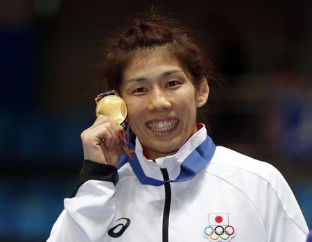 Japan's Saori Yoshida poses with her gold medal after winning the women's 55kg freestyle wrestling competition at Dowon Gymnasium during the 2014 Asian Games in Incheon September 28, 2014. REUTERS/Tim Wimborne