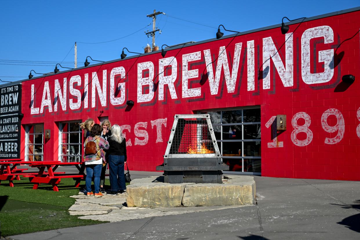 Guests congregate outside the Lansing Brewing Company on Tuesday, Feb. 20, 2024, in Lansing.