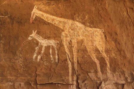 Vandalised rock art is pictured at Tadrart Acacus May 30, 2014. REUTERS/Aimen Elsahli