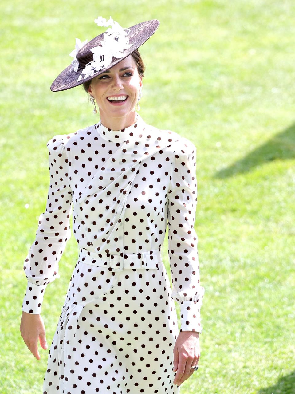 Kate Middleton smiling in a hat and white polka-dot dress