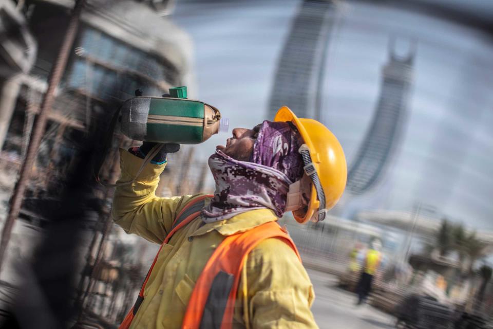 A worker on a construction site in Lusail city tries to stay hydrated.<span class="copyright">Ed Kashi—VII for TIME</span>