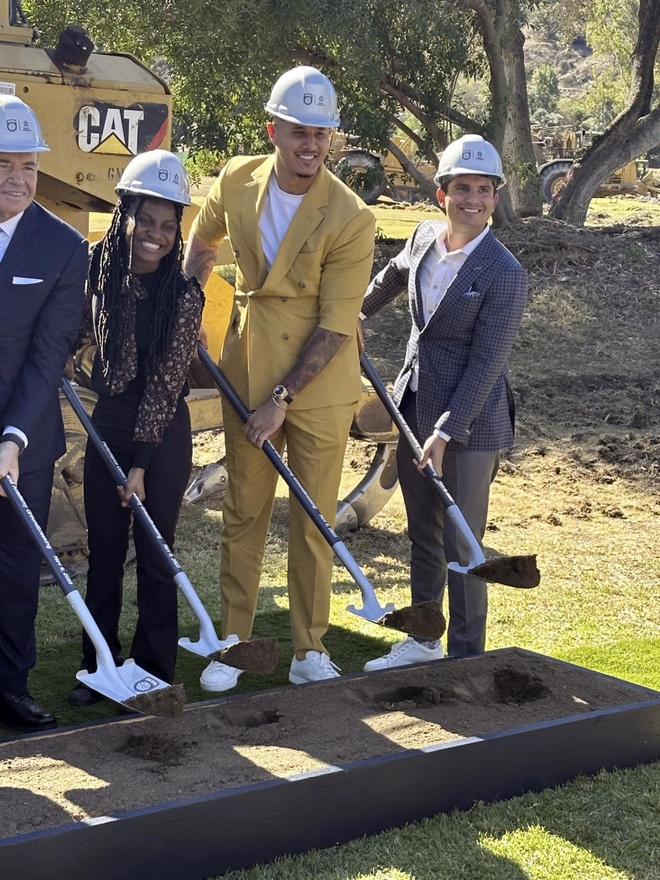 FILE - San Diego Padres slugger Manny Machado, center, a founding partner in the MLS expansion soccer club San Diego FC, participates in the ceremonial groundbreaking for a $150 million training complex and youth academy on Thursday, Nov. 9, 2023, in El Cajon, Calif. San Diego's Right to Dream academy set to join an evolving MLS academy system that's starting to pay dividends for the league internationally. (AP Photo/Bernie Wilson, File)