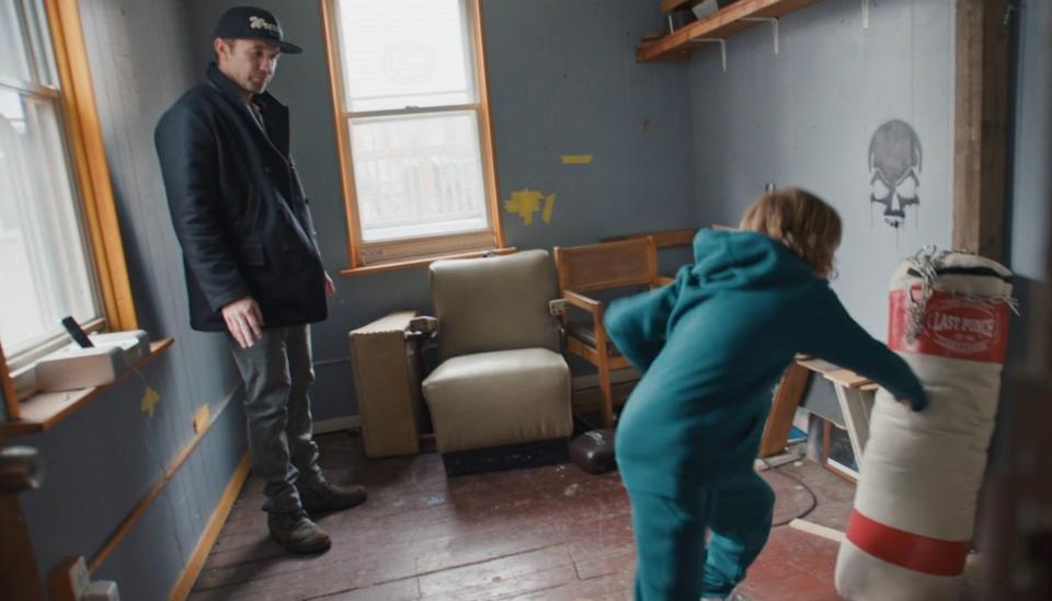 Rob McElhenney stands in his childhood home with his son