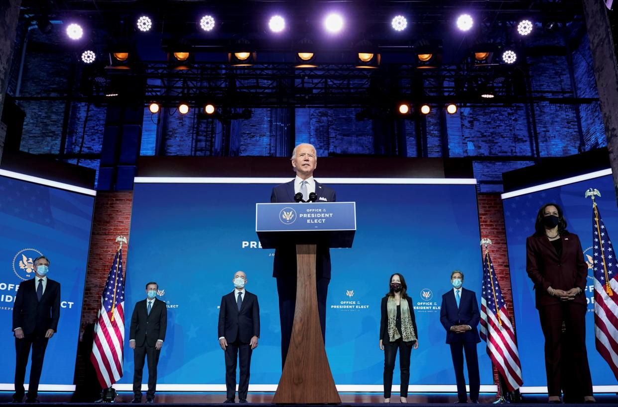President-elect Joe Biden stands with his nominees for his national security team at his transition headquarters in the Queen Theater in Wilmington, Delaware, U.S., November 24, 2020. (L-R), are: Antony Blinken to be secretary of state; Jake Sullivan to be U.S. national security adviser; Alejandro Mayorkas to be secretary of Homeland Security; Avril Haines to be director of national intelligence; John Kerry to be a special envoy for climate change; and Ambassador to the United Nations-nominee Linda Thomas-Greenfield, who stands behind Vice President-elect Kamala Haris. (Joshua Roberts/Reuters)