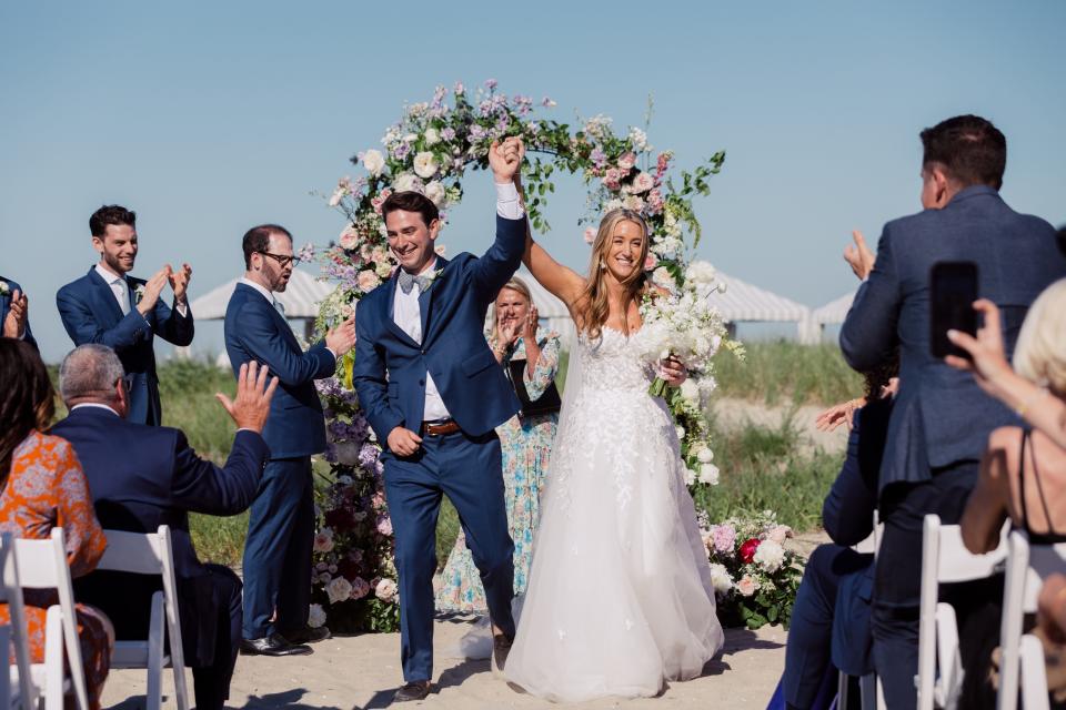 “All of my bridesmaids and I went barefoot and I ended up not wearing shoes for the rest of the night,” Kelly Wilson of New Jersey said of her 2022 beach wedding in Chatham. Wilson married Marcellus Stires.