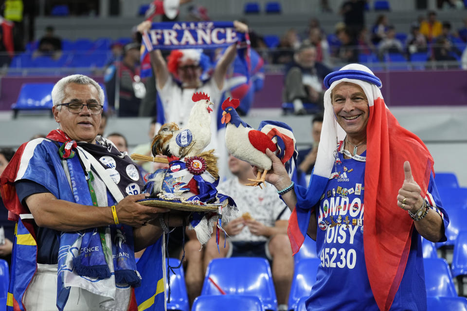 FILE - Fans of France cheer prior to the World Cup group D soccer match between France and Denmark at the Stadium 974 in Doha, Qatar, Saturday, Nov. 26, 2022. At a World Cup that has become a political lightning rod, it comes as no surprise that soccer fans’ sartorial style has sparked controversy. At the first World Cup in the Middle East, fans from around the world have refashioned traditional Gulf Arab headdresses and thobes. (AP Photo/Martin Meissner, File)