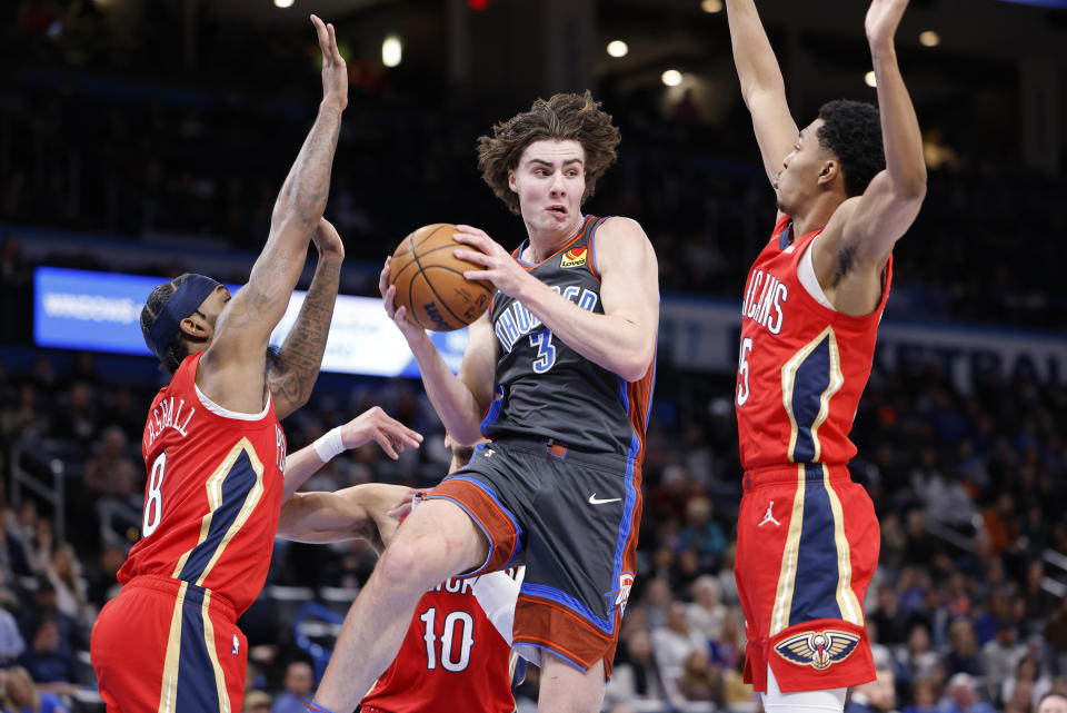 Oklahoma City Thunder guard Josh Giddey (3) goes against New Orleans Pelicans forward Naji Marshall (8), center Jaxson Hayes (10) and guard Trey Murphy III, right, during the first half of an NBA basketball game Friday, Dec. 23, 2022, in Oklahoma City. (AP Photo/Garett Fisbeck)