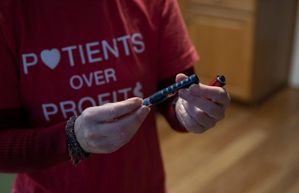 Diedre Waxman loads an insulin cartridge into her reusable pen before giving herself a shot of insulin in preparation to eat her lunch. Waxman uses her insulin pen up to six times per day, each time requiring her to replace the needle. One box of needles can cost over $50. To offset the cost of her diabetes treatments, Waxman gets her insulin in Canada.