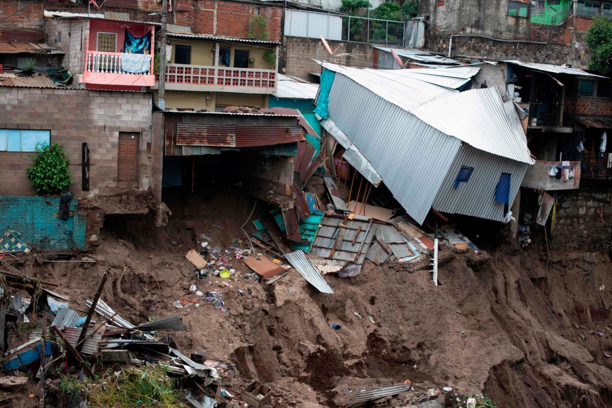 A view of houses devastated by the overflowing of a creek due to the torrential rains caused by the tropical storm Amanda in San Salvador: AFP via Getty Images