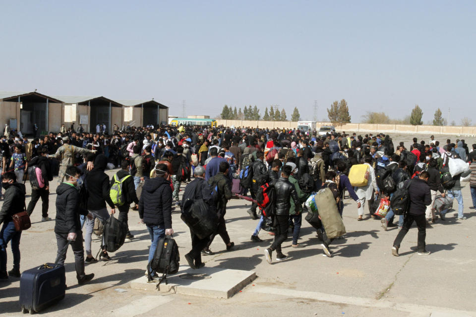 FILE - In this Wednesday, March 18, 2020 file photo, thousands of Afghan refugees walk as they enter Afghanistan at the Islam Qala border crossing with Iran, in the western Herat Province. Taliban have taken control of Islam Qala crossing border in western Herat province at the neighboring Iran, an Afghan official and Iranian media confirmed on Thursday, July 8, 2021. (AP Photo/Hamed Sarfarazi, File)