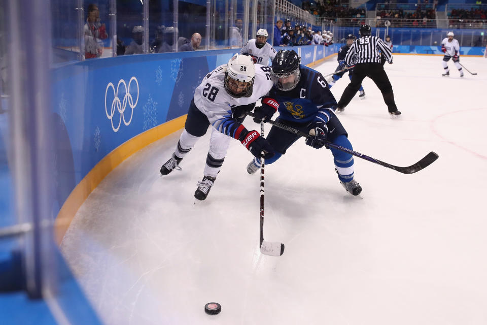 Amanda Kessel of the United States and Jenni Hiirikoski #6 of Finland battle for the puck in the first period during the Women’s Ice Hockey Preliminary Round. (Getty)