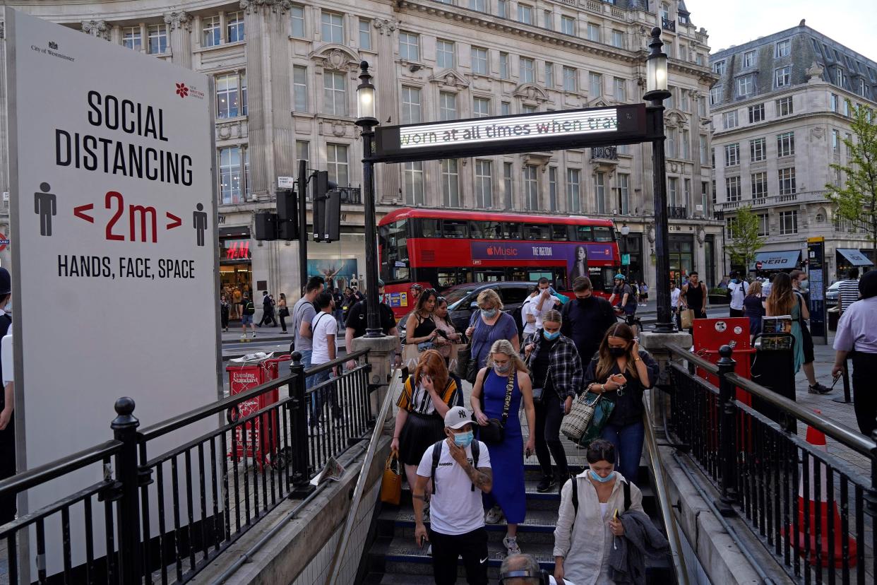 Commuters wearing face coverings due to Covid-19, enter Oxford Circus London Underground station in central London on June 7, 2021. The Delta variant of the coronavirus, first discovered in India, is estimated to be 40 percent more transmissible than the Alpha variant that caused the last wave of infections in the UK.