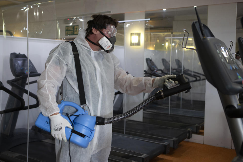 A man in a hazmat suit inside Oasis Gym as Gyms and leisure centres in the UK prepare for reopening on Saturday 25th July by installing social distancing and COVID 19 compliant signs. On July 22, 2020 in Stanford Le Hope. UK. (Photo by Jacques Feeney/MI News/NurPhoto via Getty Images)