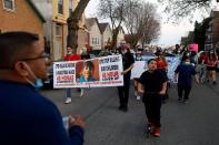 Members of Chicago's Little Village Community Council march on Tuesday, April 6, 2021 to protest against the death of 13-year-old Adam Toledo, who was shot by a Chicago Police officer at about 2 a.m. on March 29 in an alley west of the 2300 block of South Sawyer Avenue near Farragut Career Academy High School.
