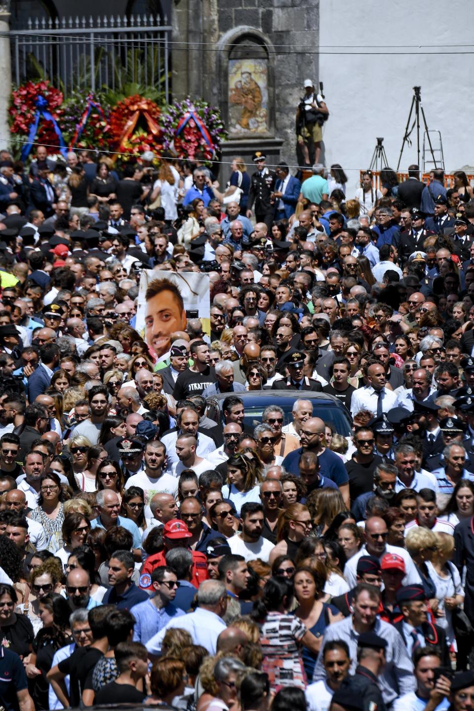 The picture of Carabinieri's officer Mario Cerciello Rega is shown during his funeral in his hometown of Somma Vesuviana, near Naples, southern Italy, Monday, July 29, 2019. Two American teenagers were jailed in Rome on Saturday as authorities investigate their alleged roles in the fatal stabbing of the Italian police officer on a street near their hotel. (Ciro Fusco/ANSA via AP)