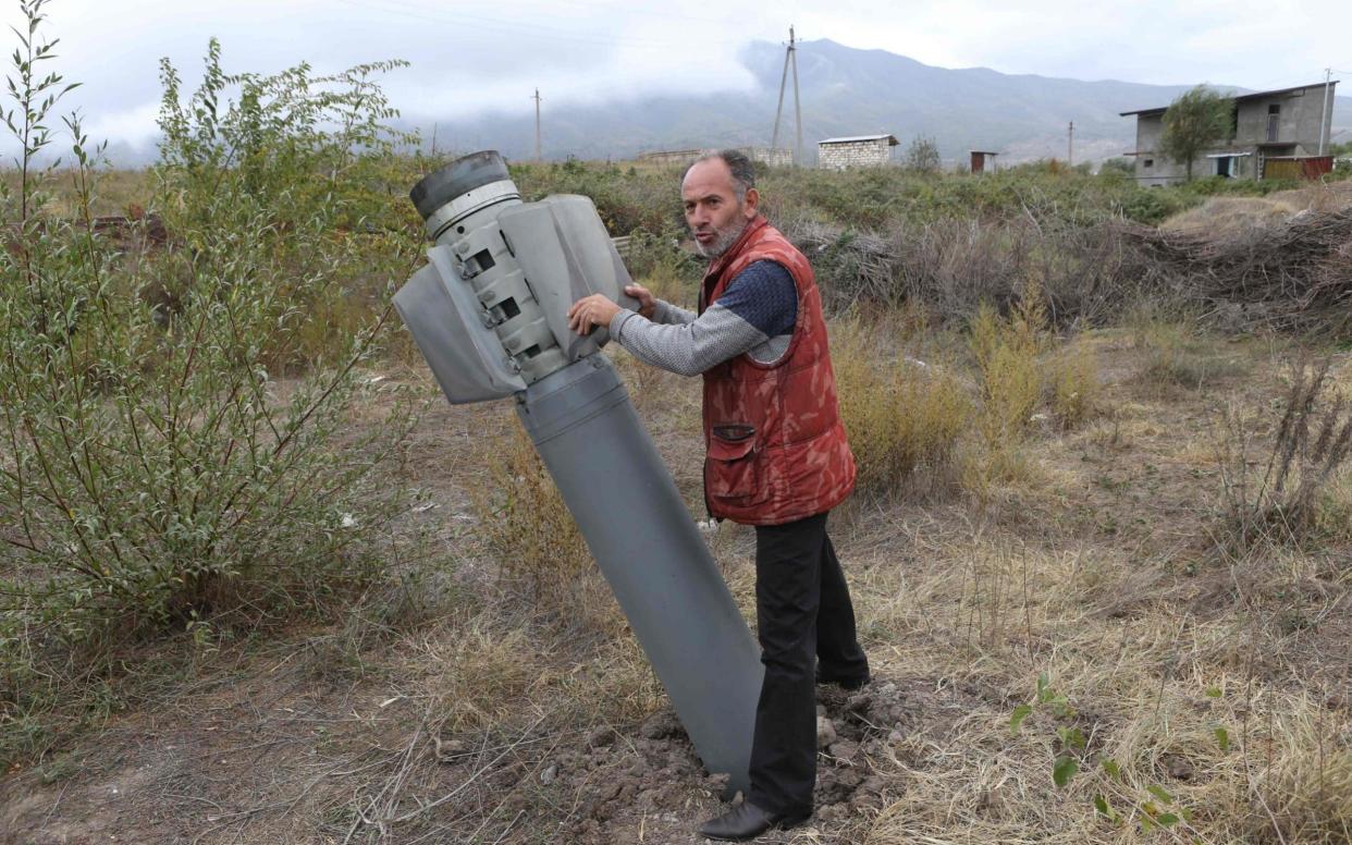 A rocket shell landed in the Ivanyan community in the breakaway Nagorny Karabakh region  - Hayk Baghdasaryan / PHOTOLURE / AFP