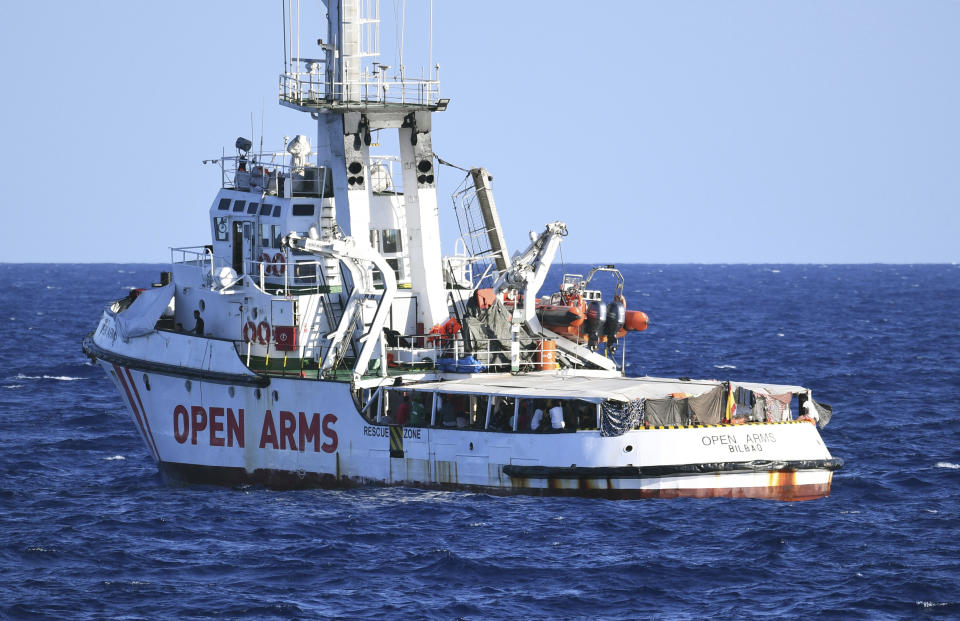 The Open Arms vessel with 107 migrants on board is anchored off the Sicilian vacation and fishing island of Lampedusa, southern Italy, Monday, Aug. 19, 2019. Open Arms on Monday suggested chartering a plane to fly to Spain the migrants blocked off the coast of Italy aboard its boat since early August, to end a stalemate with the Italian Interior minister Matteo Salvini, who won't let private rescue boats into his nation's ports. (AP Photo/Salvatore Cavalli)