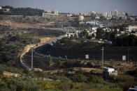 Roadworks expand a road to Israeli settlements inside the West Bank, near the city of Bethlehem, Sunday, Nov. 29, 2020. In years to come, Israelis will be able to commute into Jerusalem and Tel Aviv from settlements deep inside the West Bank via highways, tunnels and overpasses that cut a wide berth around Palestinian towns. Rights groups say the new roads that are being built will set the stage for explosive settlement growth, even if President-elect Joe Biden's administration somehow convinces Israel to curb its housing construction. (AP Photo/Majdi Mohammed)