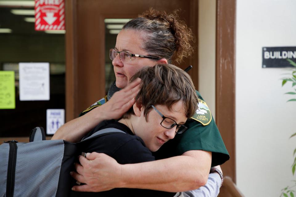 Leon County Sheriff's Department Deputy Jennifer Morris, school resource officer at Cobb Middle School, hugs sixth grader Jake West in the hall between classes Tuesday, Feb. 12, 2019. 