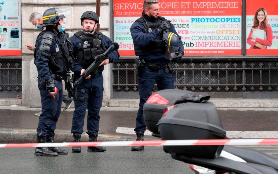 French police officers cordon off the scene - GEOFFROY VAN DER HASSELT /AFP