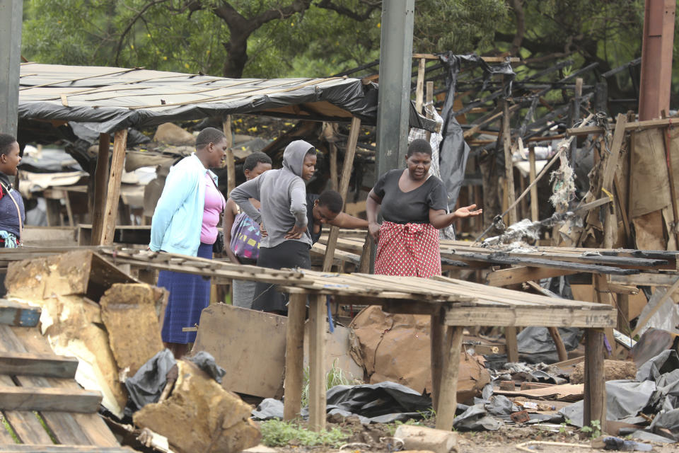 Women inspect their stalls at a market after they were destroyed during demonstrations over the hike in fuel prices in Harare, Zimbabwe, Tuesday, Jan. 15, 2019. Soldiers moved in to disperse crowds at the busy intersection and transport hub in Harare amid Zimbabwe's biggest unrest since deadly post-election violence in August. (AP Photo/Tsvangirayi Mukwazhi)