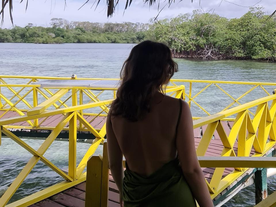 eibhlis looking out over the ocean from the deck of her overwater bungalow