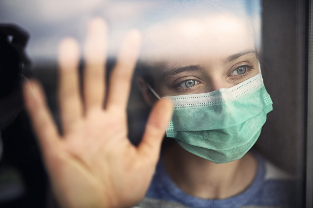 Portrait of a teenage girl wearing anti virus mask learning against a window.
Shot with Nikon D850