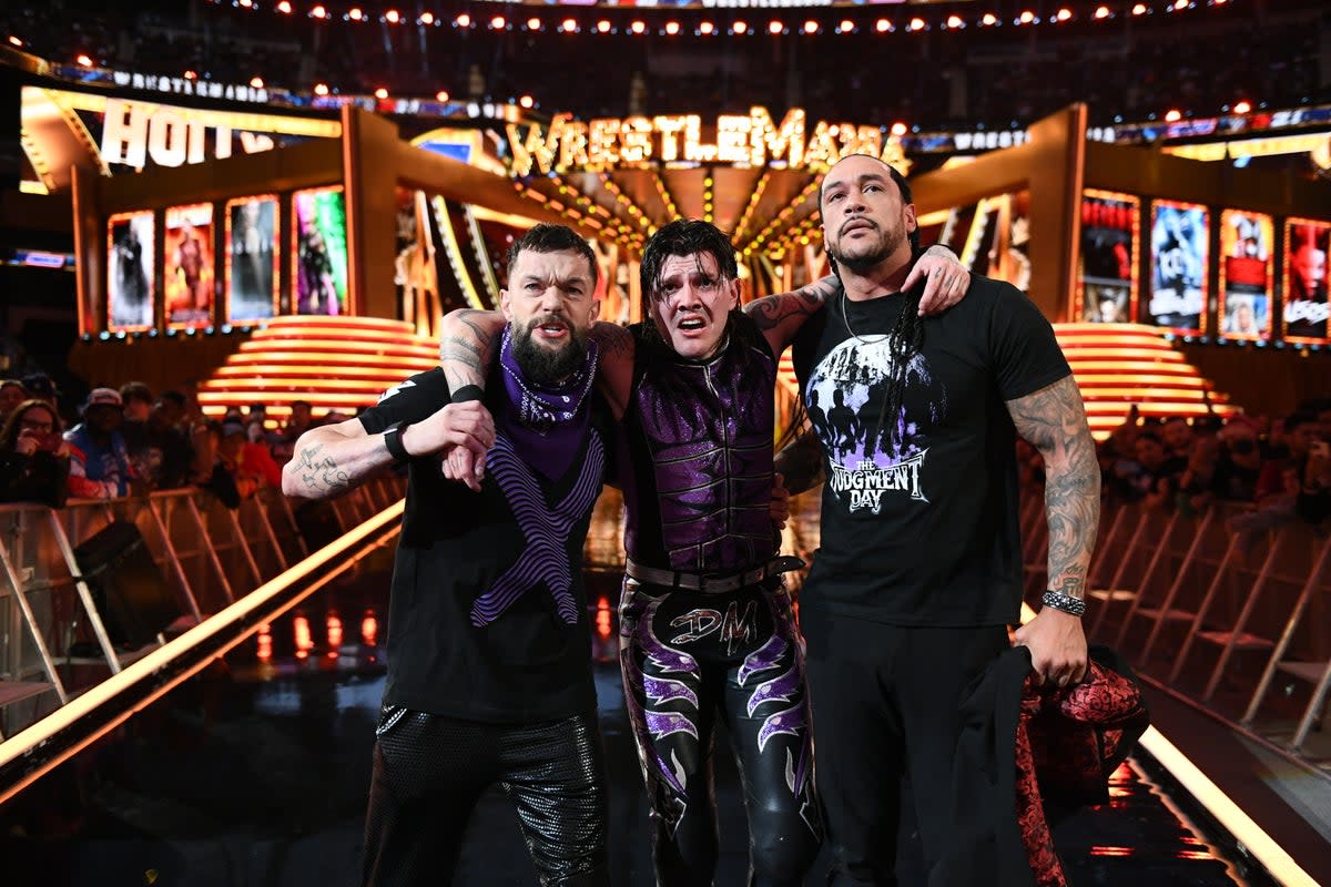 Mysterio with teammates Finn Balor (left) and Damian Priest (WWE)