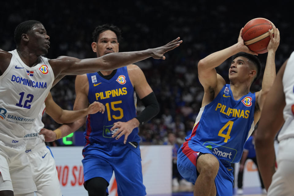 Philippines guard Kiefer Ravena (4) shoots against Dominican Republic forward Angel Delgado (12) during the Basketball World Cup at the Philippine Arena in Bulacan province, Philippines Friday, Aug. 25, 2023. (AP Photo/Aaron Favila)