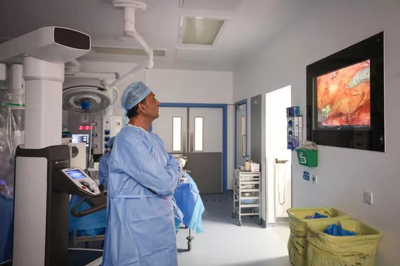 Mr Ramani guides the team through the operation -Credit:Kenny Brown | Manchester Evening News