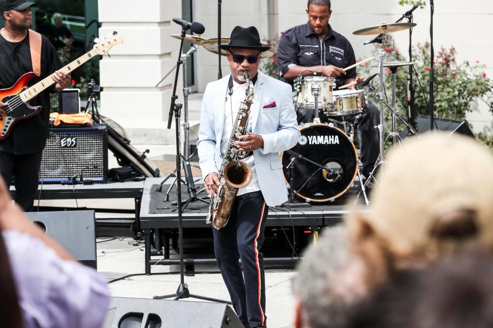 Memphian and Grammy-winning saxophonist Kirk Whalum plays for a crowd after being honored with a note on the Beale Street Brass Note Walk of Fame during a ceremony at the Halloran Centre plaza on Sept. 12, 2018.
