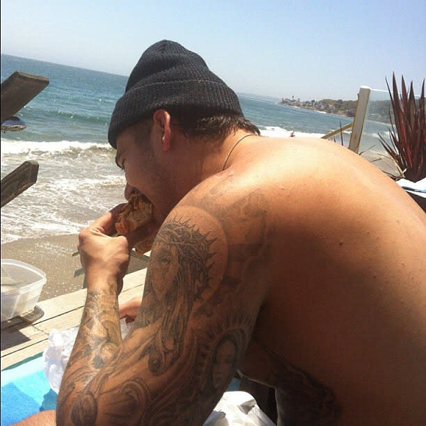 One of the more reclusive members of the Kardashian clan may finally be warming up to social media. Rob Kardashian made a return to his neglected Instagram account on Thursday to post a #TBT photo to time spent in Malibu. Although he doesn't say when exactly the photo was originally snapped, we can see Rob shirtless as he chows down on a pulled pork sandwich. <strong>WATCH: Kris Jenner Worries Rob Kardashian Is 'Going to Die,' Says He's Gained 100 Pounds In the Last Year</strong> The photo comes as somewhat of a surprise, as Rob has not only removed himself from the spotlight, but he's also been criticized as of late for his noticeable weight gain. Last April, Rob's mom, Kris Jenner, was on the verge of tears over his weight gain, but recently, his siblings have spoken lovingly about him. Just last week, his step-sister Kendall Jenner posted a throwback of her own that showed Rob laughing during an episode of <em>Keeping Up With the Kardashians</em> that aired in 2012, and his older sister Khloe Kardashian revealed that she has taken Rob into her home. <strong>PHOTOS: Wilmer Valderama Shares Hilarious #TBT in Support of Demi Lovato</strong> "Rob lives with me now and I wouldn't have it any other way. I love having him with me," Khloe told <em>Complex</em> magazine. "He's going through a hard time now and it's behind gates. With this crazy lifestyle you have to think of places where you can still have your freedom." Hopefully, this is a sign that Kardashian fans will see more of Rob in the upcoming season of <em>KUWTK</em> or in Caitlyn Jenner's new show, <em>I Am Cait</em>, where he briefly appeared in the premiere. See more from the premiere of <em>I Am Cait</em> in the video below.