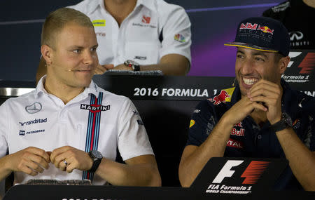 Williams' Valtteri Bottas of Finland (L) and Red Bull's Daniel Ricciardo of Australia react at a news conference ahead of the Singapore F1 Grand Prix Night Race in Singapore, September 15, 2016. REUTERS/Jeremy Lee