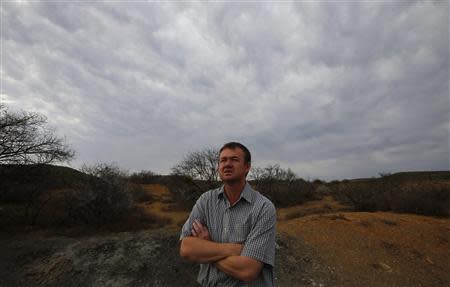 Game farmer Hennie Barnard looks out over his land near Aberdeen in the Karoo October 10, 2013. REUTERS/Mike Hutchings