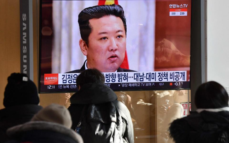 People watch a news programme showing a North Korean supreme leader Kim Jong-un - AFP