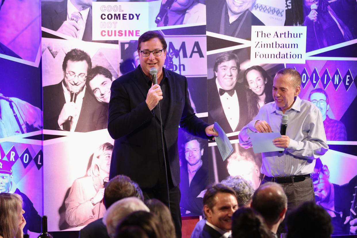 Bob Saget (L) and Gilbert Gottfried speak onstage during the Scleroderma Research Foundation's 30th Anniversary Cool Comedy - Hot Cuisine at Caroline's Comedy Club on Dec. 5, 2017, in New York City.