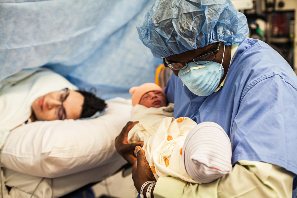 "Directly after a C-section&nbsp;delivery, the nurse placed these twin babies in their father's arms for the very first time. There was so much love in the room."