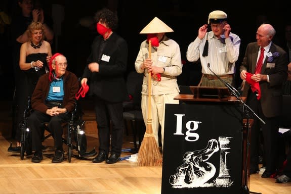 A group of Nobel laureates and writers at the 2010 Ig Nobel awards. The scientists are trying out a safety bra that contains a gas mask, one of the devices that won an Ig Nobel prize. (From left: Paeco Todd, Bill Lipscomb, Neil Gaiman, Roy Glau