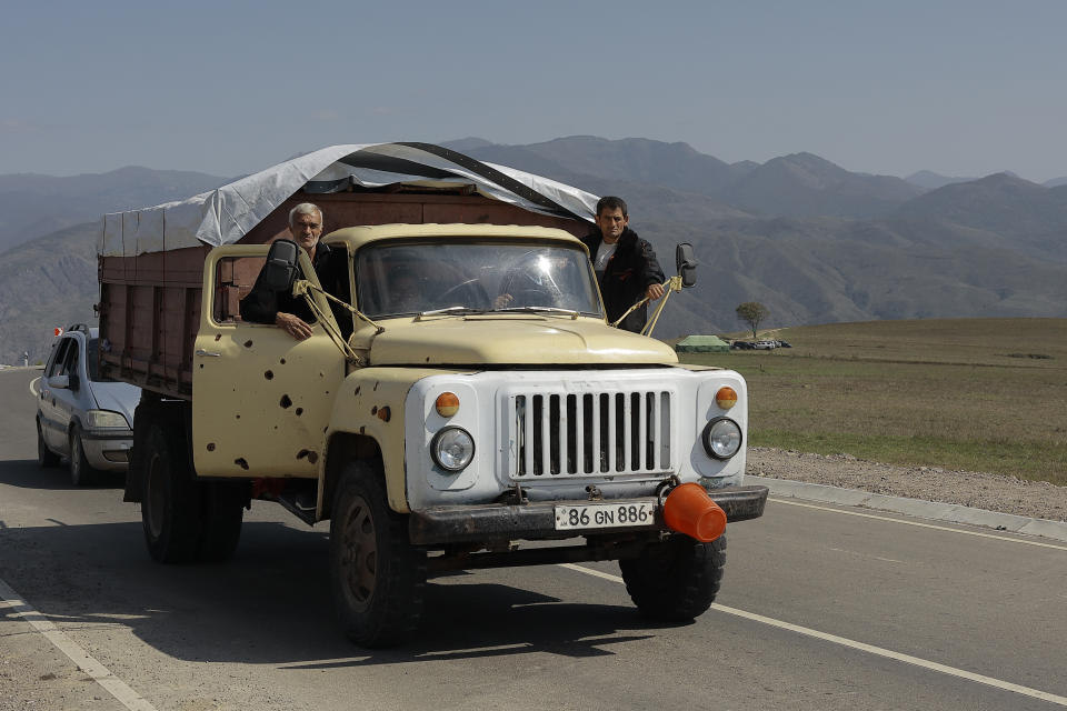 Ethnic Armenians from Nagorno-Karabakh drive a truck on the road from Nagorno-Karabakh to Armenia's Kornidzor in Syunik region, Armenia, Friday, Sept. 29, 2023. More than 70% of Nagorno-Karabakh's original population has fled to Armenia as the region's separatist government said it will dissolve itself and the unrecognized republic inside Azerbaijan will cease to exist by year’s end after a three-decade bid for independence. (AP Photo/Vasily Krestyaninov)
