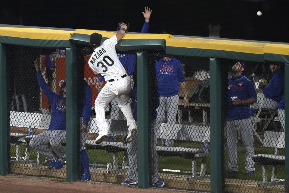 Chicago White Sox right fielder Nomar Mazara cannot make the play on a ball hit for a two-run home run by Chicago Cubs' Victor Caratini during the sixth inning of a baseball game in Chicago, Friday, Sept. 25, 2020. (AP Photo/Nam Y. Huh)