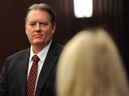 Michael Dunn looks at his family during a morning recess at his murder trial in the shooting death of unarmed teen Jordan Davis, in Duval County Courthouse in Jacksonville, Florida on February 10, 2014. Dunn is accused of first degree murder in death of Davis after an altercation over loud rap music at a Florida gas station in November 2012. REUTERS/Bob Mack/Pool