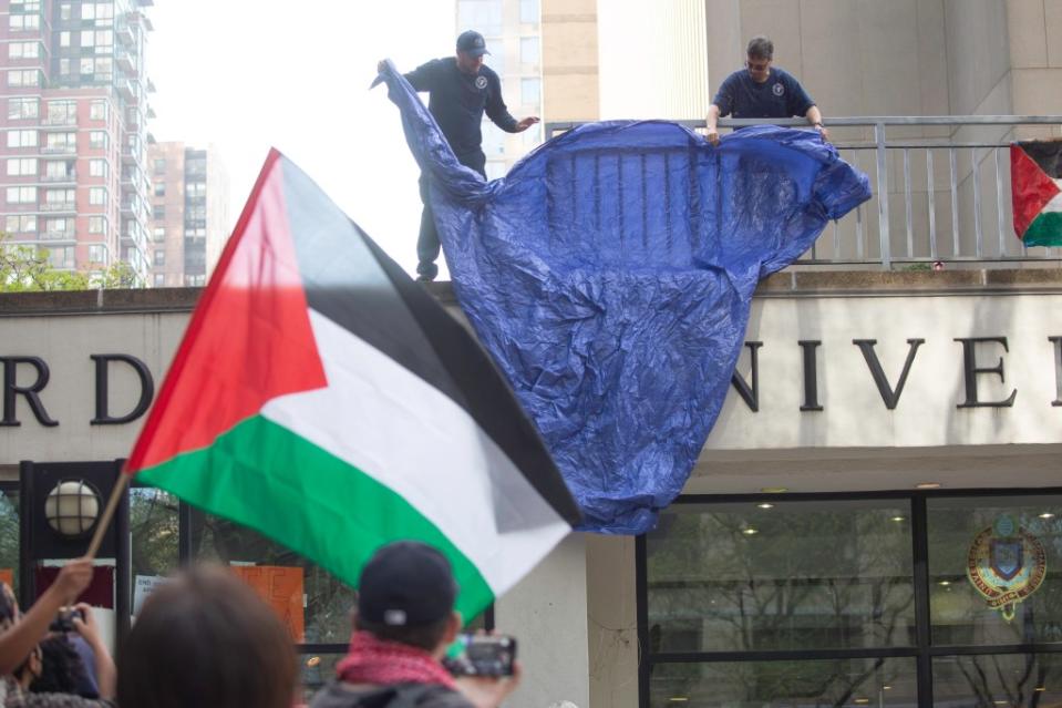 Police draped a blue tarp over the window before making arrests. James Messerschmidt